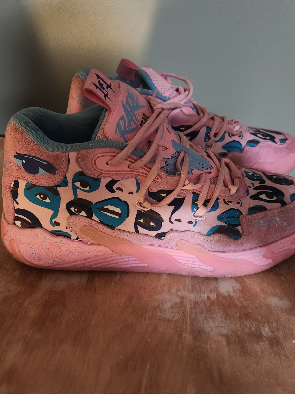 The shoes shown in the image are the PUMA x KidSuper MB.03 "Pink Lilac" Shoe